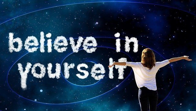 believe in yourself written in white on blue sky improve your personal development