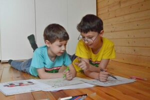 two young boys in class home schooling options child's leadership skills