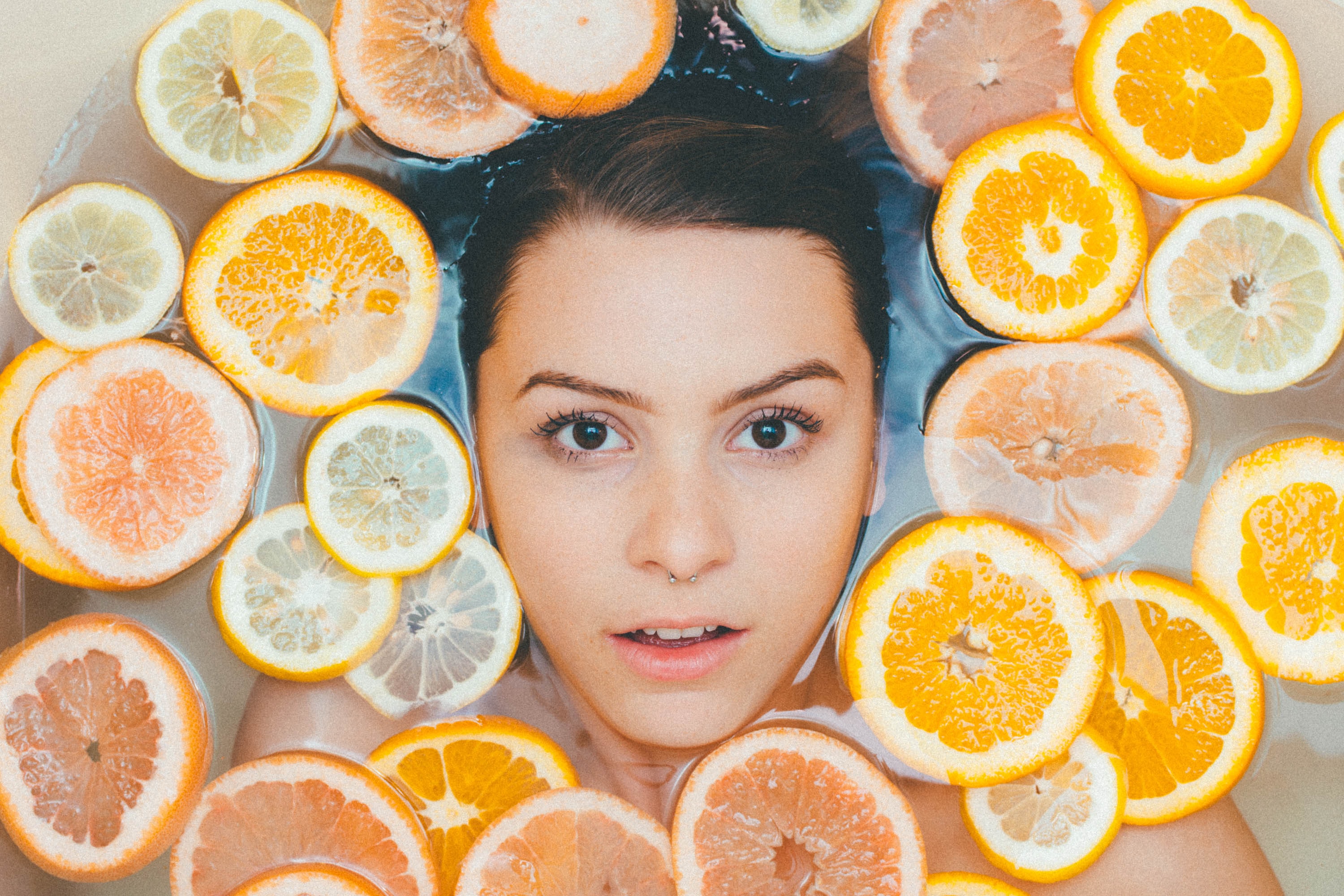 Filipino Skincare Claims woman face surrounded by orange lemon slices