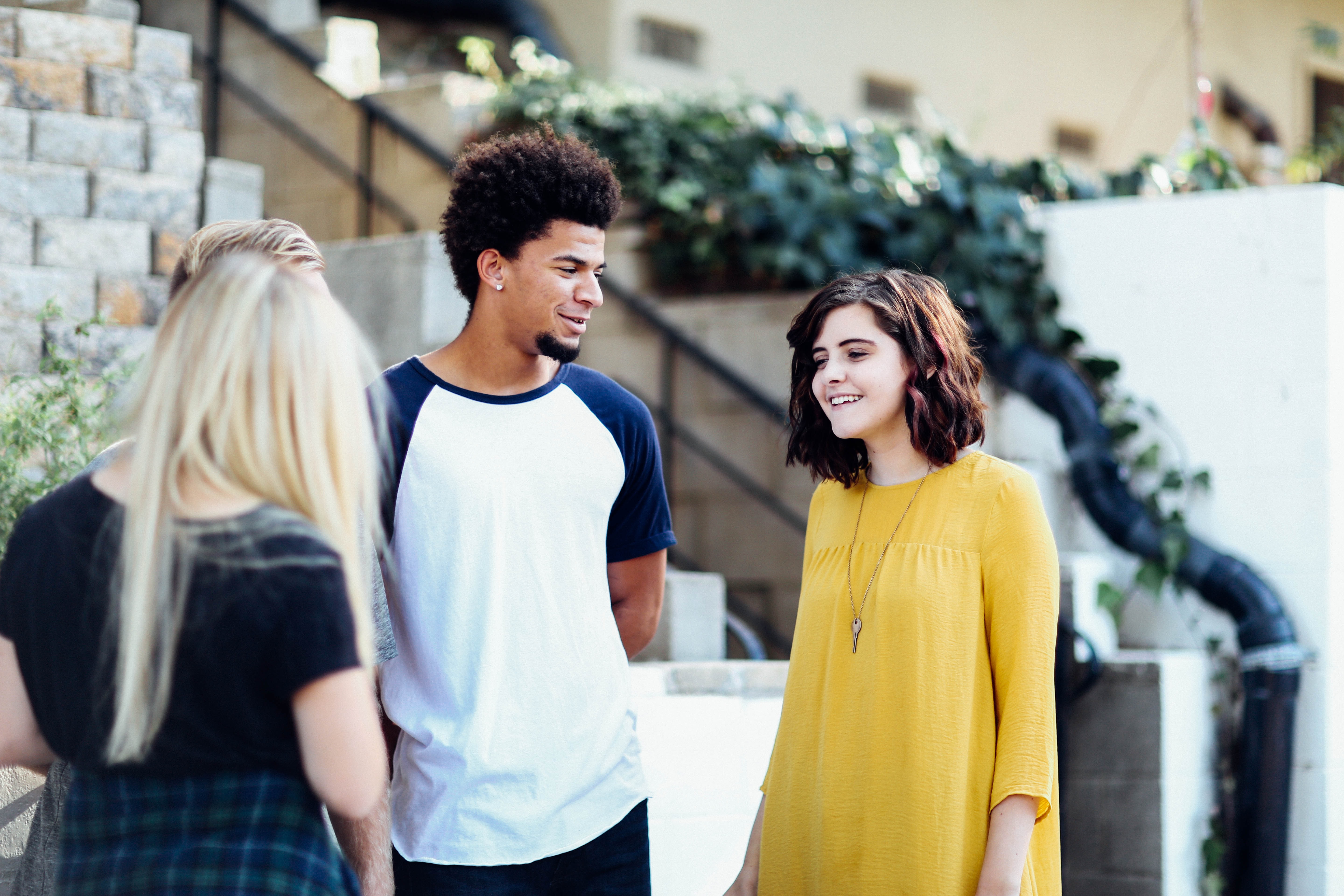 two women and a man students at international schools talking