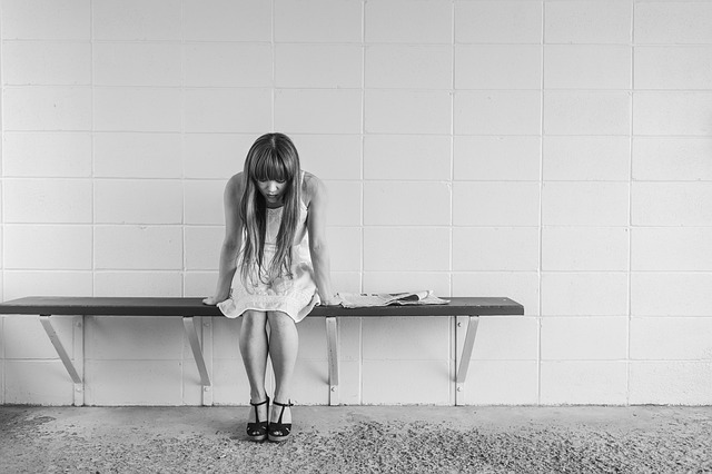 how to handle stress girl sitting on a bench with head down