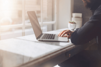 man at office time management improvement open laptop